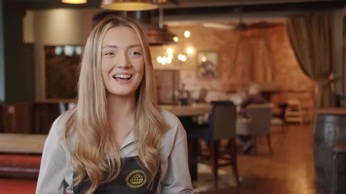 A female waitress smiling